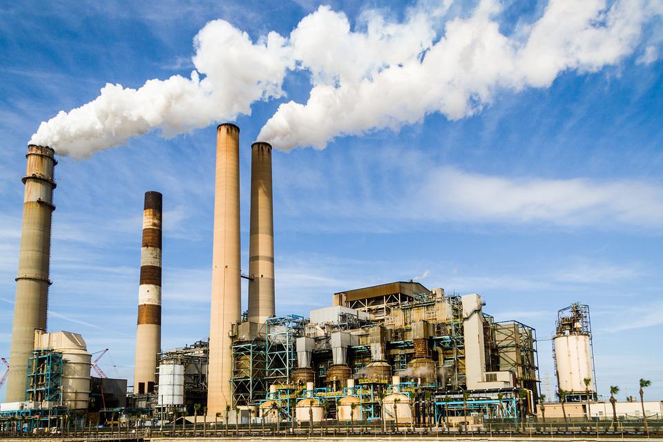 photo of an industrial building with smoke stacks